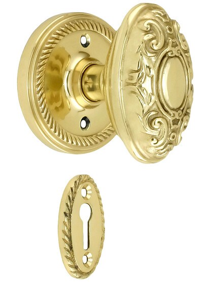Rope Rosette Mortise Lock Set With Decorative Oval Knobs in Polished Brass finish.